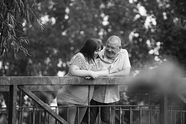 unposed natural photo of couple on bridge talking