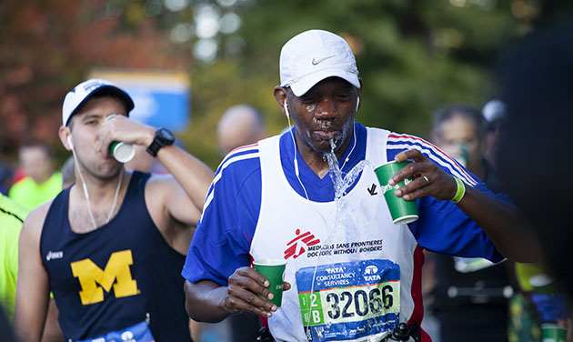 NYC marathon runner throwing water on face