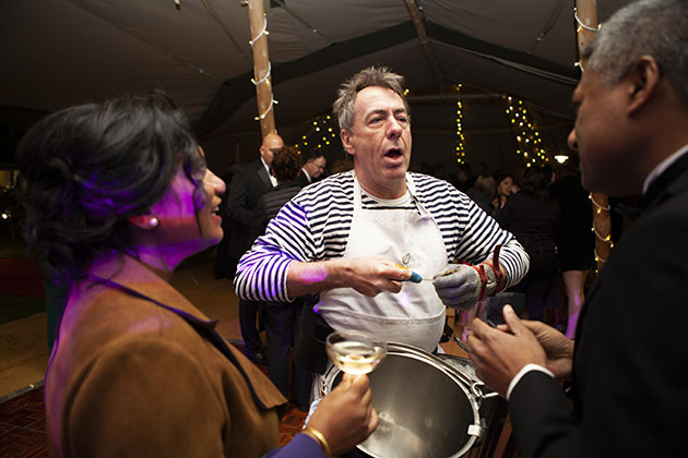 Man serving oysters at a party