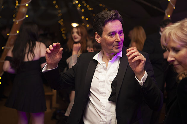 Man in suit dancing at a party