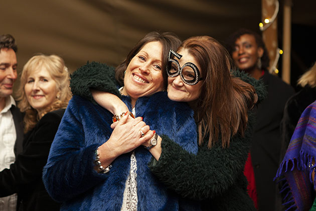Two women hugging at a social function