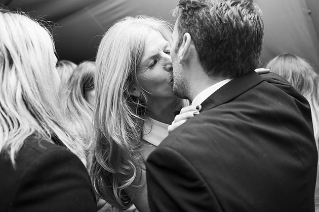 Woman and man kissing at a party