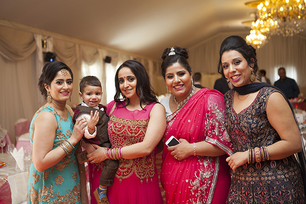 Guests at a party in traditional Indian sari dresses
