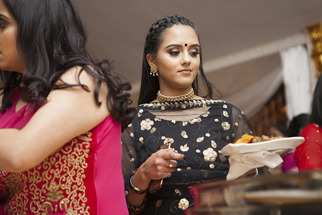 Young girl at an Indian buffet table