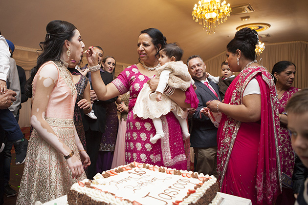 Tradition of feeding birthday cake to a young Indian girl