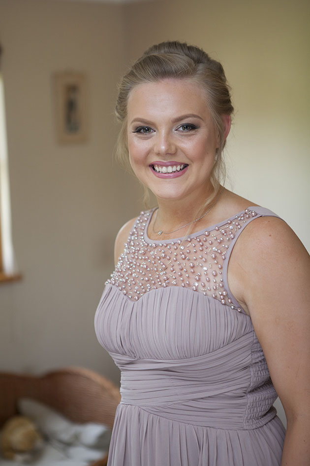 portrait of smiling bridesmaid looking at camera
