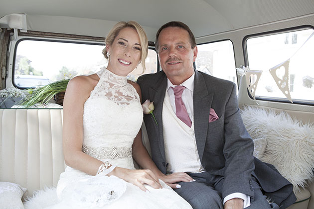 bride with her father in back of VW kombi van before wedding