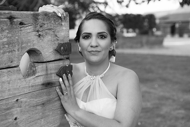 Relaxed portrait of bride holding wooden stocks