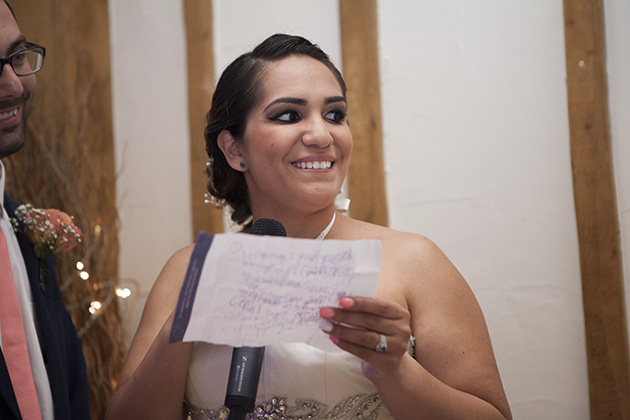 Bride making a wedding speech and holding a written note