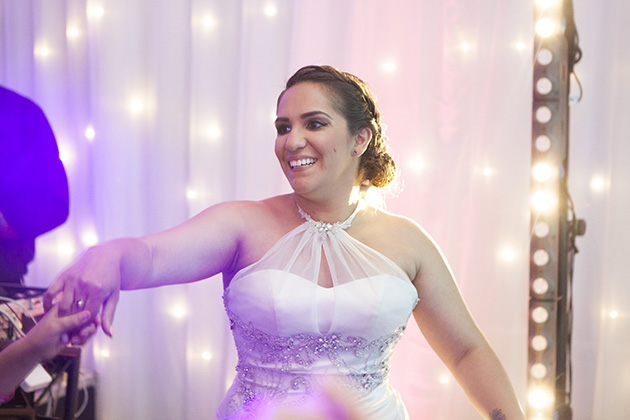 Bride dancing with twinkling lights in the background