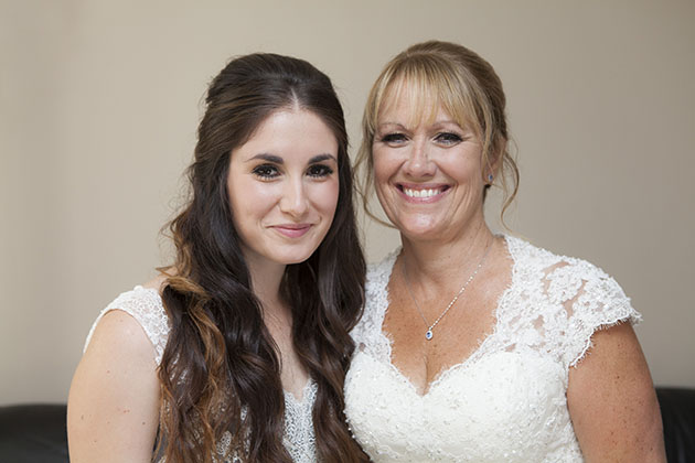 Portrait of bride with her daughter both looking at camera