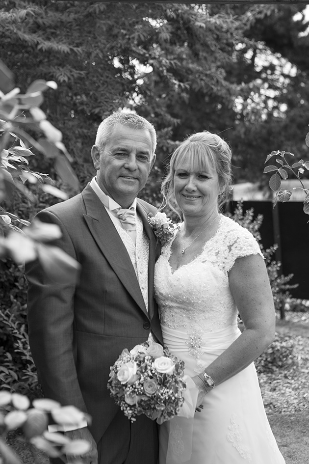 Black and white portrait of bride and groom in garden at Little Channels