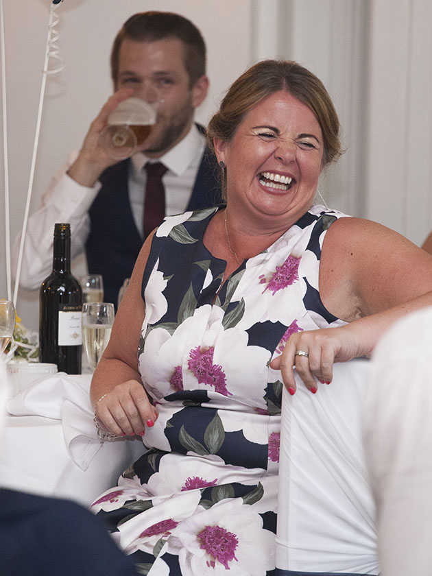 Wedding guest laughing during wedding speeches