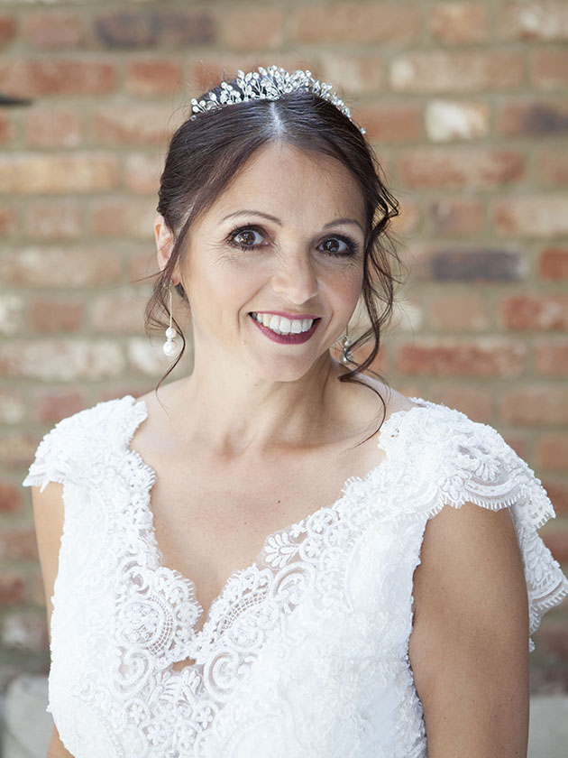 Relaxed portrait of bride with a brick wall in background