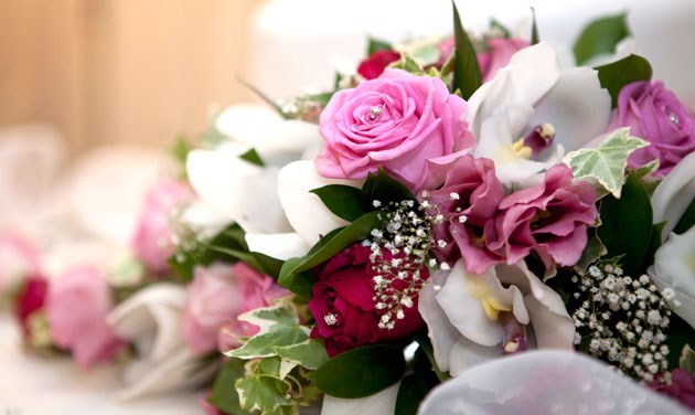close up of pink and white flowers on the wedding top table