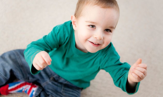 toddler in green top and union jack socks photographed from above