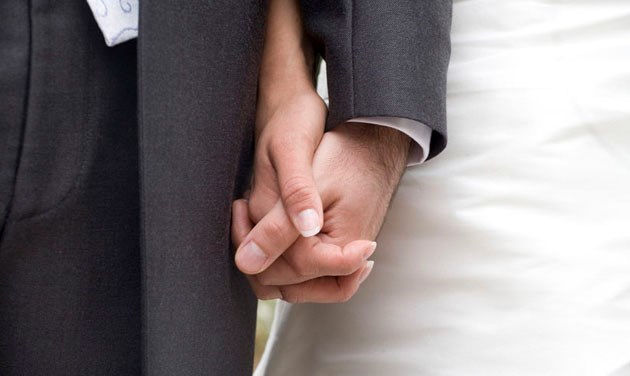 close up of hands of bride and groom