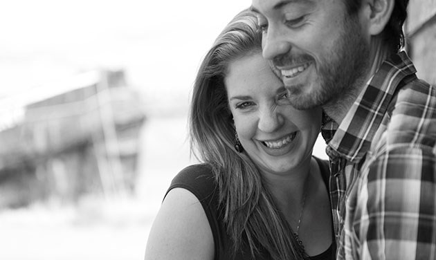 engagement shoot in Essex with woman laughing with her head on man's shoulder