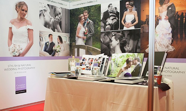 our exhibition stand with table of wedding albums at Heart FM wedding show in Brentwood