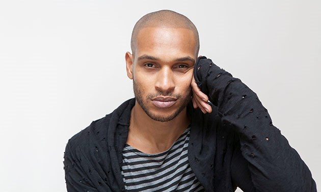 natural studio portrait of young man looking straight at camera