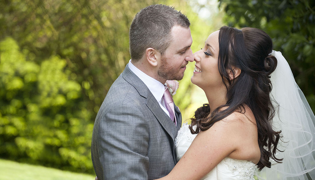 bride and groom facing each other and about to kiss