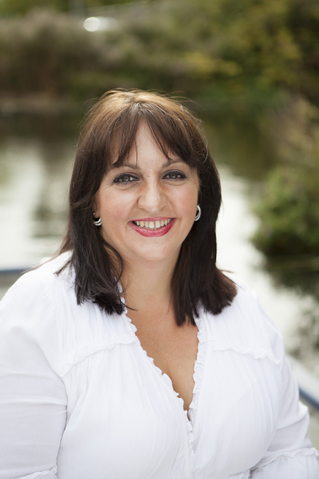 bride-to-be wearing white looking at camera with River Chelmer in background