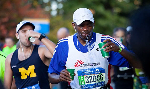 NYC marathon runner throwing water on face