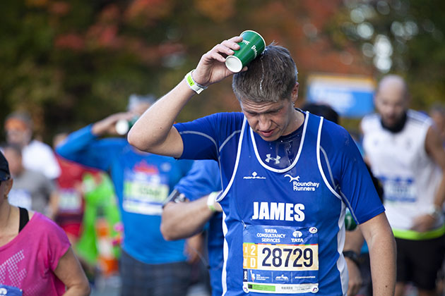 NYC 2016 marathon runner pouring water over head