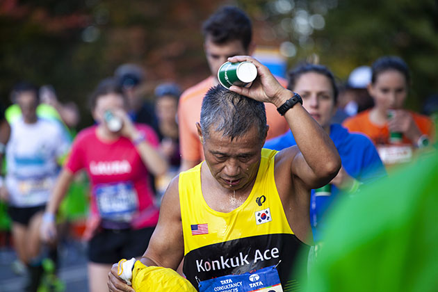 NYC 2016 marathon runner pouring water over head