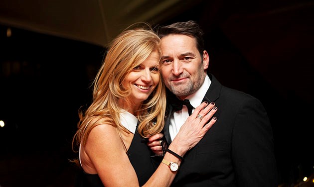 Portrait of husband at wife at a black tie party looking at camera