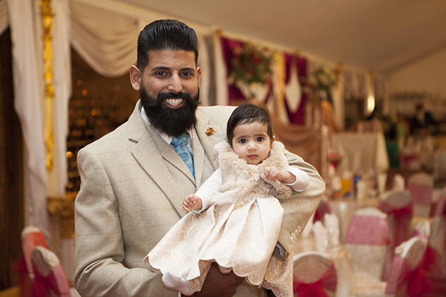 Father holding newborn daughter