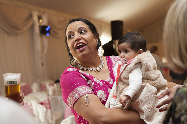 Candid photo of grandmother holding grand daughter