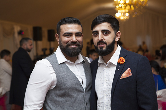 Two men at a party looking at camera