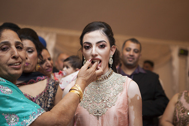 Tradition of feeding cake to a young Indian girl