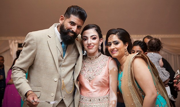 Three people looking at camera at a birthday party