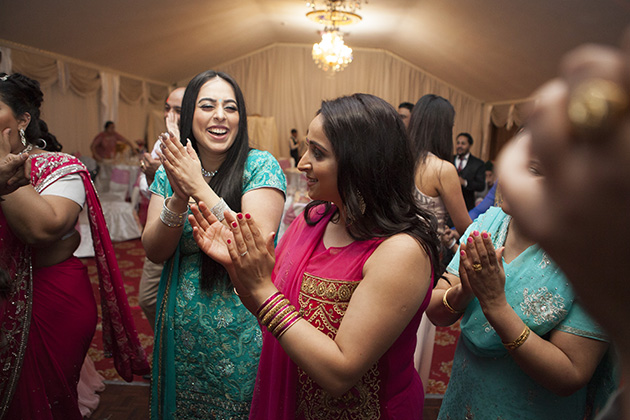 Crowd of women clapping hands on the dance floor