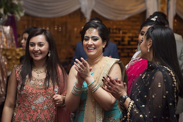 Indian women clapping hands and laughing