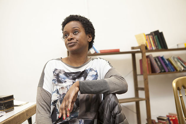 Actor Valerie Paul in rehearsal sitting on a chair and rolling her eyes