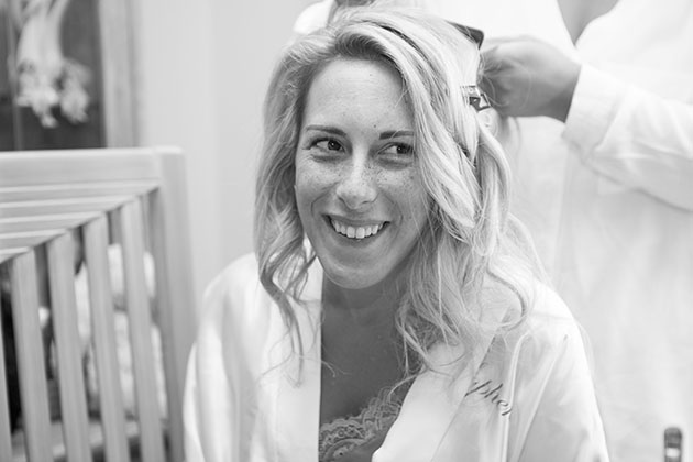 bride looking to the side whilst having her hair done