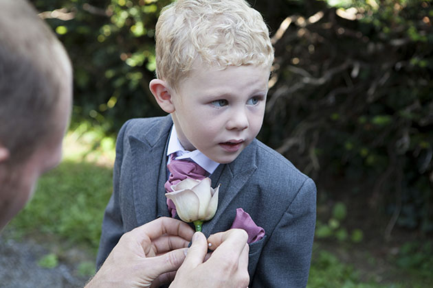 young page boy having a flower button hole attached