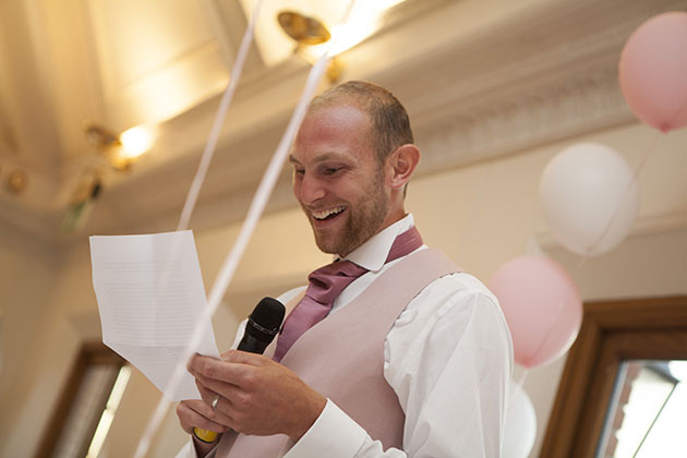 low angle photo of groom as he's making his wedding speech