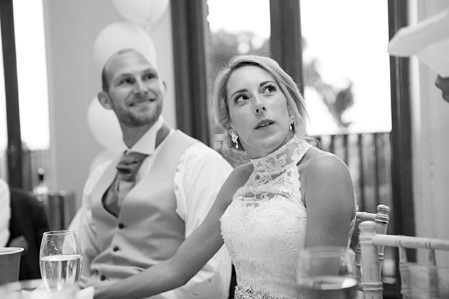 bride looking up at best man making his wedding speech