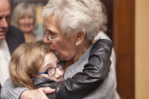 Old woman and young girl having a hug