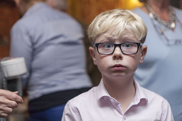 Informal portrait of a young boy wearing glasses