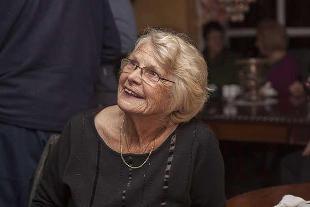 Woman sitting down at a family party and looking up