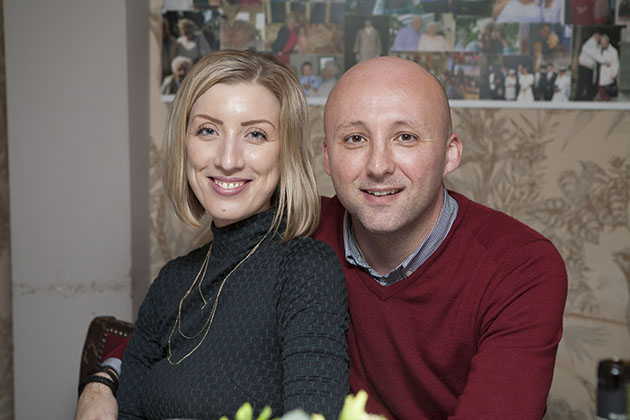 Couple at a family party looking at the camera