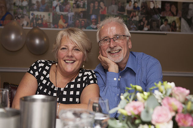 Couple at a family party looking at the camera