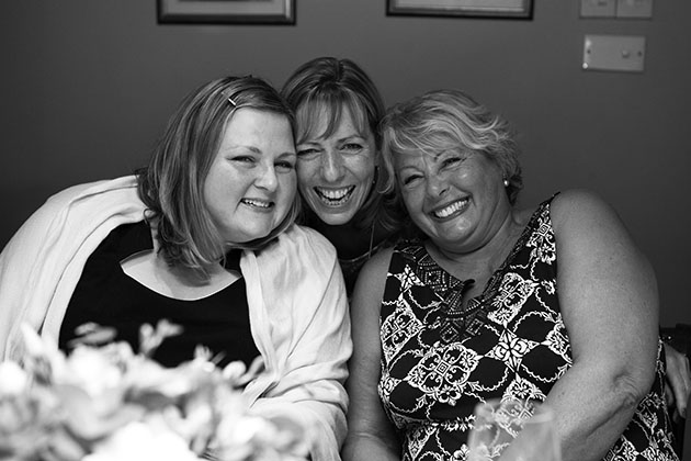 Group of three women at a family party looking at the camera