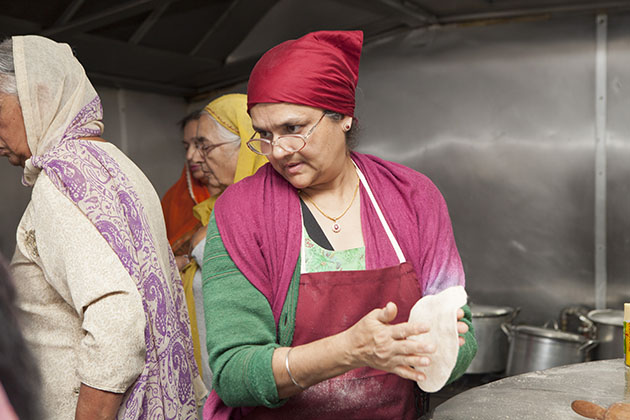 Indian woman in a kitchen looking to the side