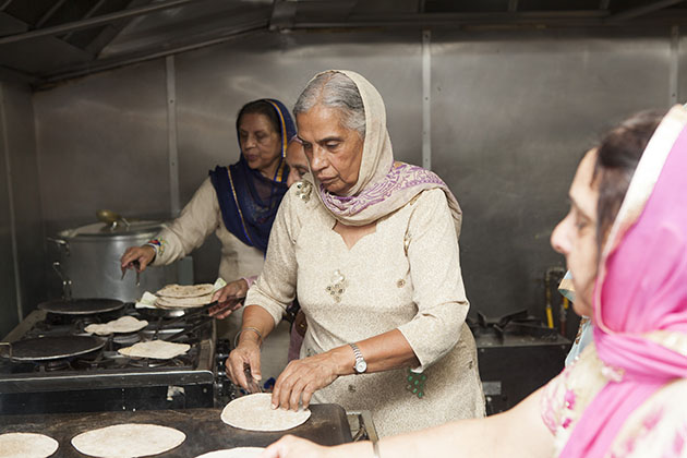 Indian women making chapati in large kitchen